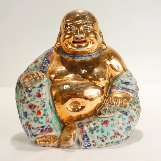 A fine vintage Chinese porcelain statue. In the form of a Luohan or Arhat with a famille verte robe and gilt body. The...