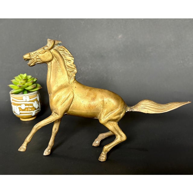 Beautiful vintage brass running horse figure. Measuring approximately 11" long by 8" tall, this striking sculpture...