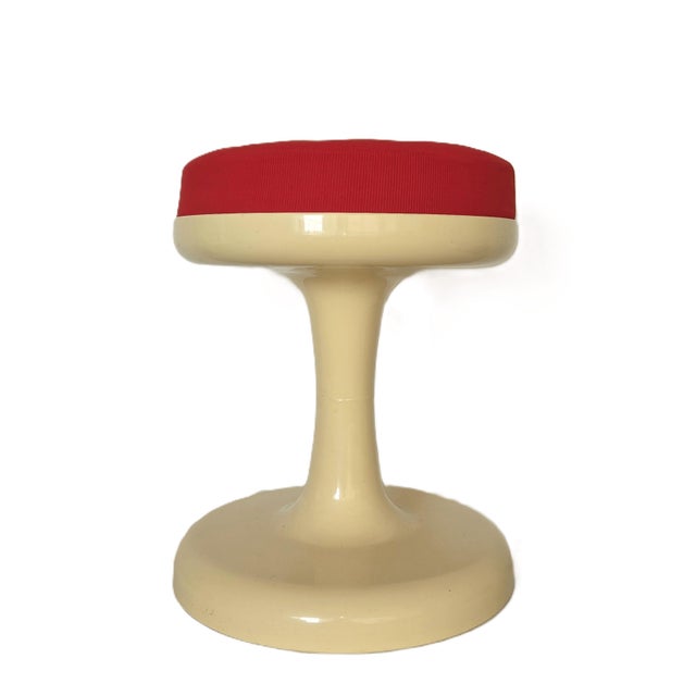 An iconic plastic stool in vanilla/butter with red fabric cushion on top, it was designed by Friedrich Stuckenbröker circa...