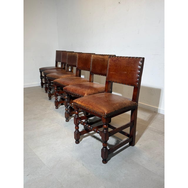 Beautiful set of six antique dining chairs crafted in solid oak, featuring rich patina and characterful turned legs. The...