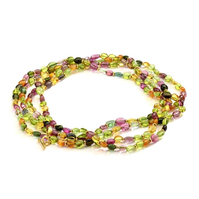 18 karat yellow gold Citrine, Peridot, Tourmaline & Mandarin garnet beads Length 60 inch Small toggle clasp Strung on silk...