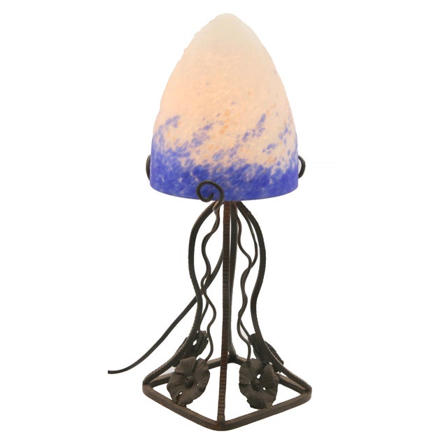 A wonderful pair of french lamps. The stands are handmade in wrought iron with black finish patina and hammered with...