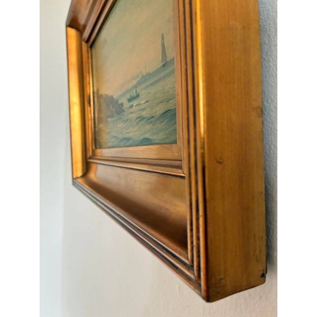 This original antique seascape oil painting, from around 1900, shows a rocky shoreline, a small rowing boat and distant...