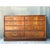 This vintage Drexel campaign dresser is a striking example of mid-20th-century case goods, distinguished by its warm,...