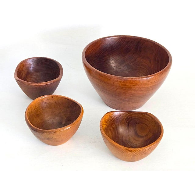 Offered is a set of 4 hand-carved teak wood cone shaped bowls. The large bowl has a straight angled rim and the 3...
