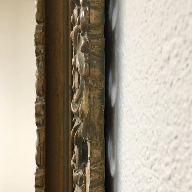 Solid wood, Baroque-style mirror with rich hand-carved shell & foliate carvings in a matte, antique bronze finish, with...