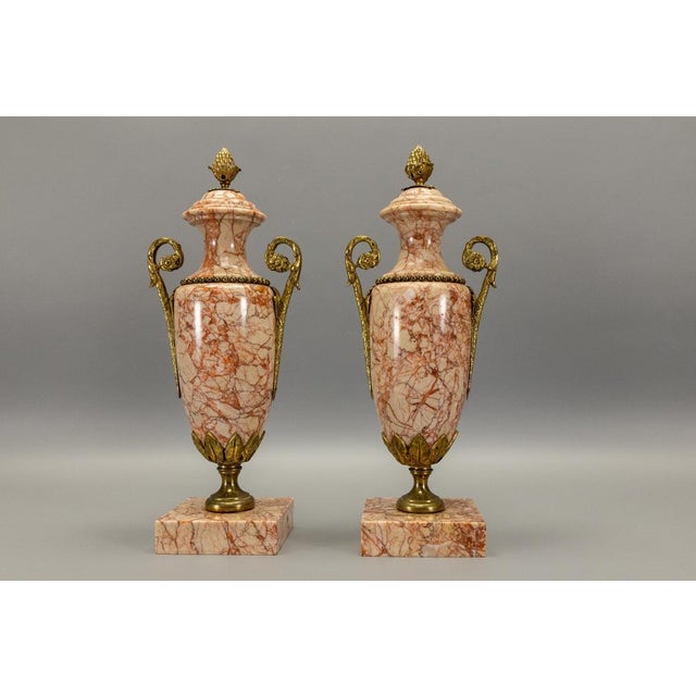 Pair of French marble cassolettes with bronze mounts, early 20th century. Elegant decorative urns in a classical...