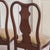 A set of four high-backed chairs in the Queen Anne style, dating from around 1890, with a vase-shaped crossbar and...