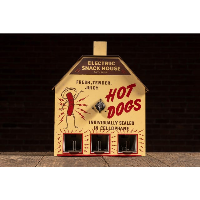Countertop "Electric Snack House" hot dog warmer with a house-form sheet metal body, pitched roof, and chimney-style vent....