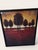 This framed art print features a beautiful scene of a red field with silhouetted trees against a warm orange sky. The...