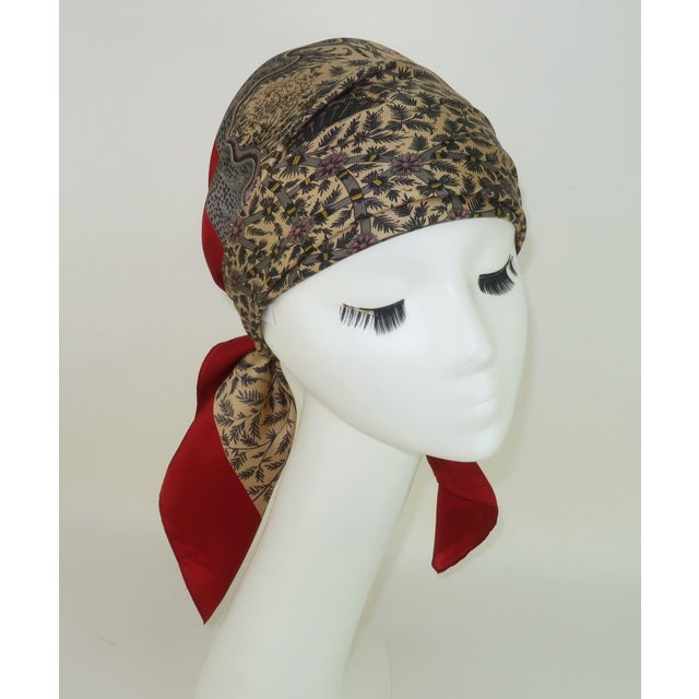 A Liberty of London silk scarf depicting an intricate and endlessly fascinating design entitled 'Peacock Garden' after the...