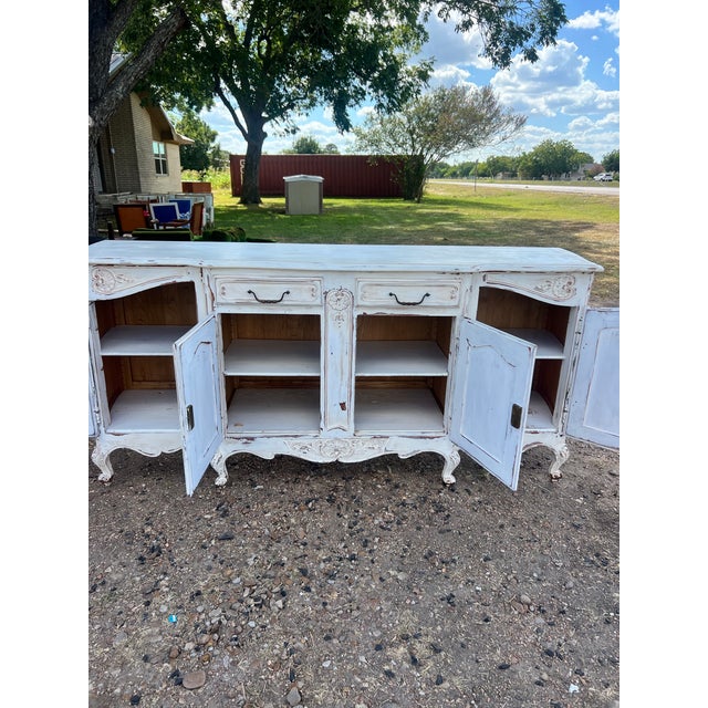 Elegant French 19th-century Louis XV sideboard crafted in walnut and finished in a charming distressed painted white...