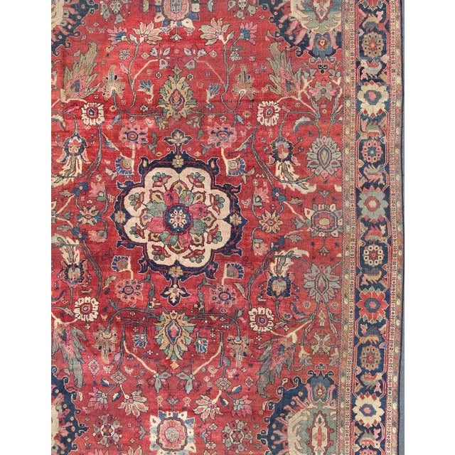 Late 19th century Antique Persian Sultanabad rug with red background, cream large scale medallion and large scale floral...