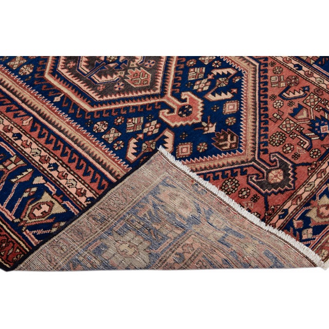 Beautiful Vintage Persian hand-knotted Wool rug with the red field. This Persian rug has a multicolor accents in all over...