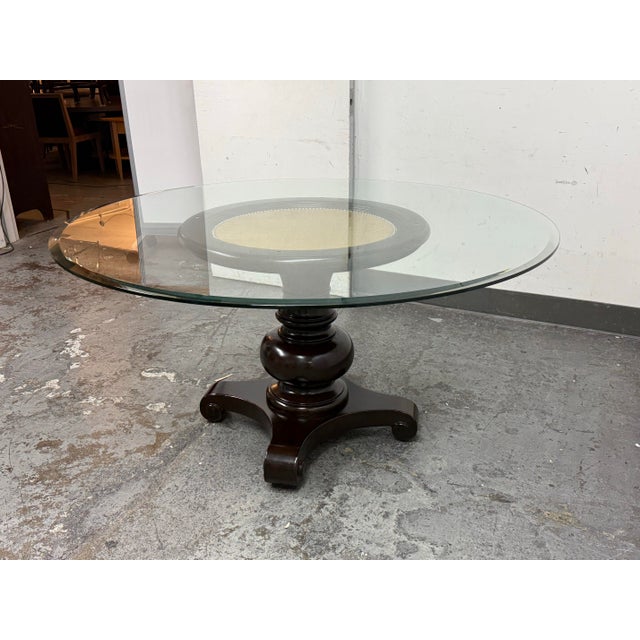 Design Plus Gallery presents a Dark Wood Finish Dining Table with Pedestal Base and Tempered Glass Table Top. The turned...
