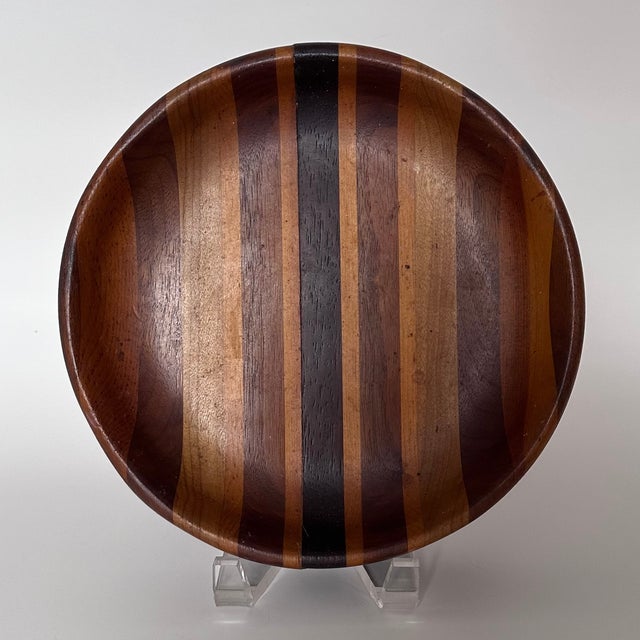 Vintage handmade lineal segmented shallow wood bowl. Dated to mid-20th century. Beautifully crafted with various types of...