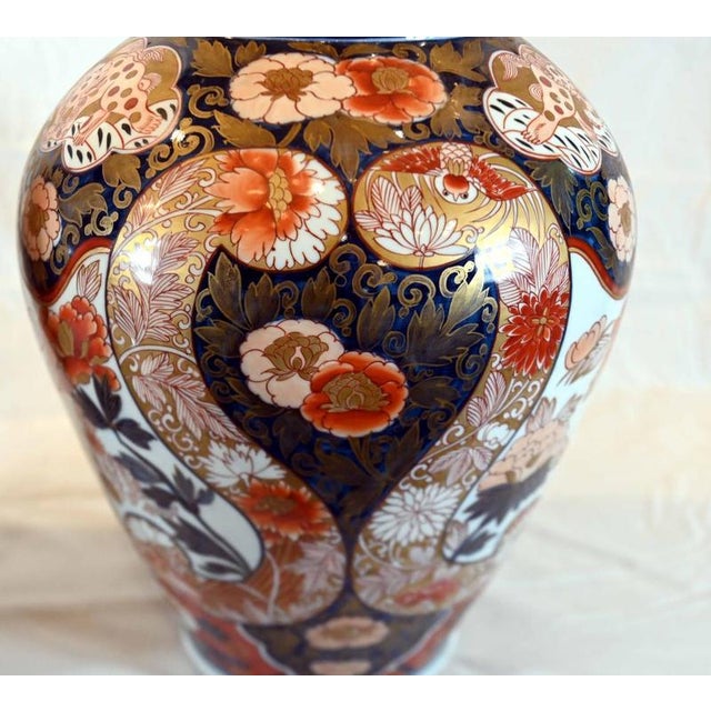 A magnificent pair of Japanese Imari porcelain lidded vases dating to the late 19th century Circa 1860 Each vase is richly...