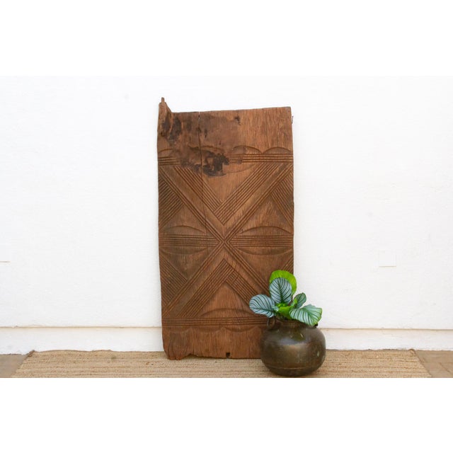 Look closely at the four quadrants framing the central cross on this door and you'll find carved eyes looking back, Anya,...