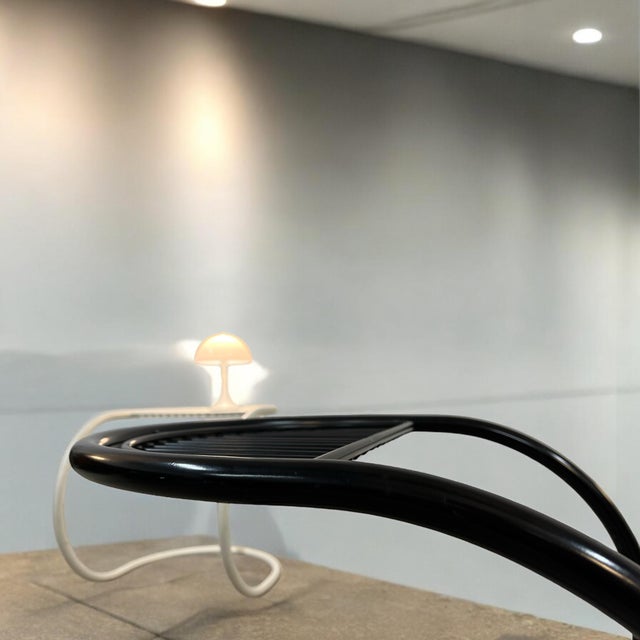 Space-age inspired nightstand executed in tubular steel. the sculptural frame is formed from precision-bent steel tubing...