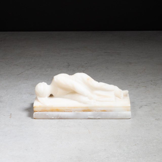 ABOUT A 19th c. hand-carved Italian alabaster miniature sculpture on marble base depicts the martyrdom of Saint Cecilia,...