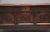 17th Century oak coffer with the hinged three panelled top above a three panelled front with carved decoration, a...