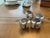 Add organic texture and effortless coastal charm to your dining space with this set of four natural Tiger Cowrie shell...