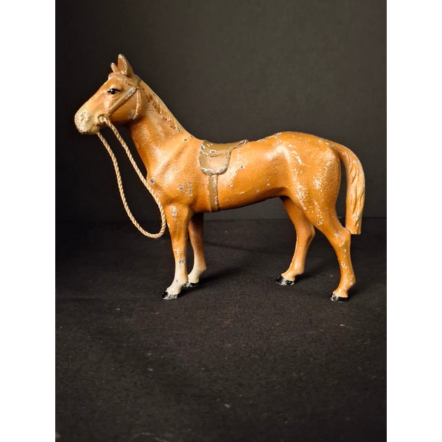 Early 20th-century American cast iron standing horse figure, likely manufactured by the Hubley Manufacturing Company of...