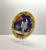 A bold blue and yellow decorative porcelain charger plate, hand-crafted in Japan around the 1920s. Hand-painted with a...
