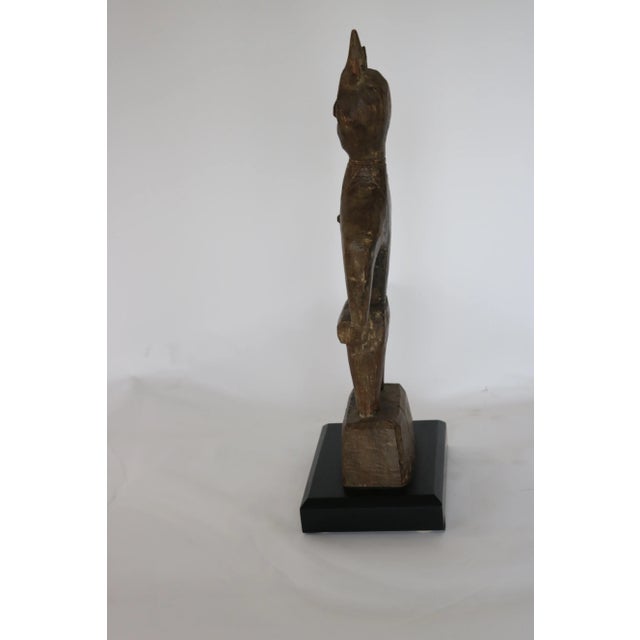 Teak wood carved male figure from Nagaland India. On mahogany base .