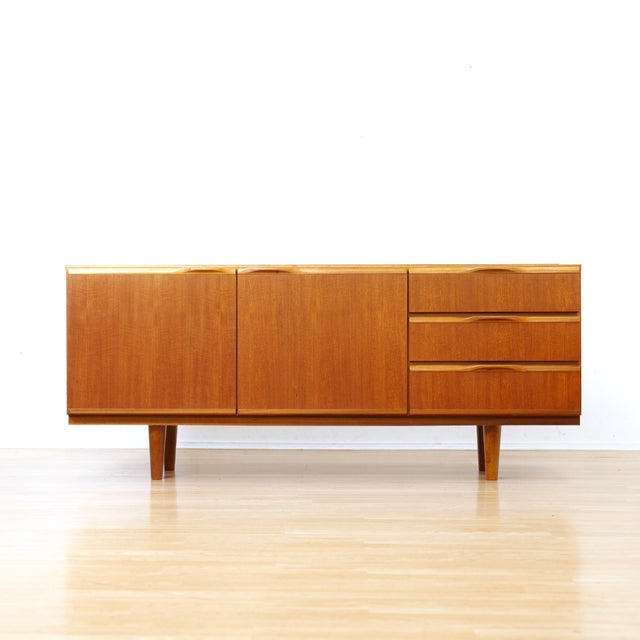 This stunning vintage credenza was produced by McIntosh of Kirkcaldy in Scotland during the 1960s. A minimalist design...