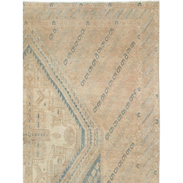 This mid-20th-century Persian Afshar rug presents a restrained geometric composition in warm beige, sand, ivory, and soft...