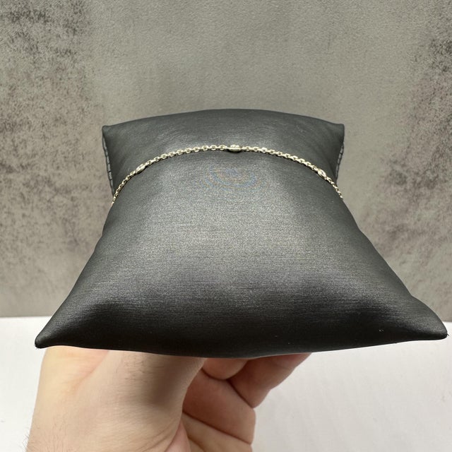 This elegant diamond station bracelet in 14kt yellow gold features 0.22 carats total weight of natural GH SI2–I1 round...