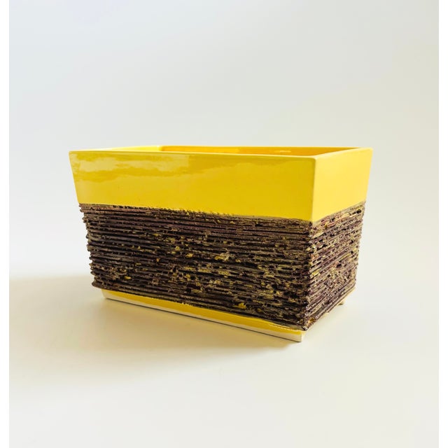 A mid century vintage rectangular ceramic planter. Glossy yellow glaze with a textured brown base. Made in California by...