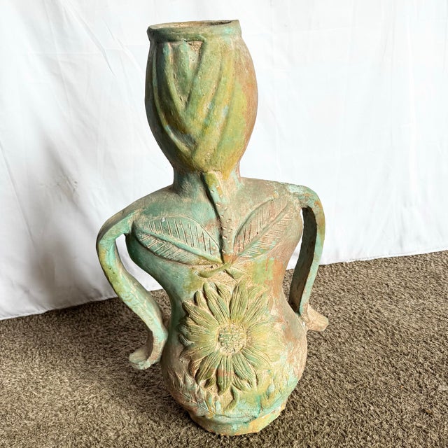 Evoking earthy femininity and botanical grace, this vintage ceramic vase is sculpted in the form of a curvaceous female...