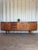 This large mid-century teak sideboard by greaves & thomas exemplifies the elegance and functionality of british modernist...