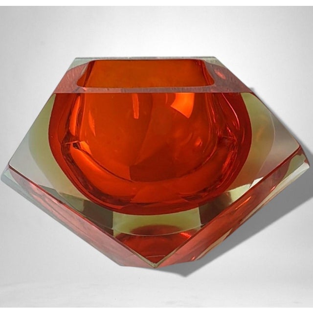 A substantial and distinctive Murano glass ashtray characterized by a bold, sculptural profile with sharply cut edges and...