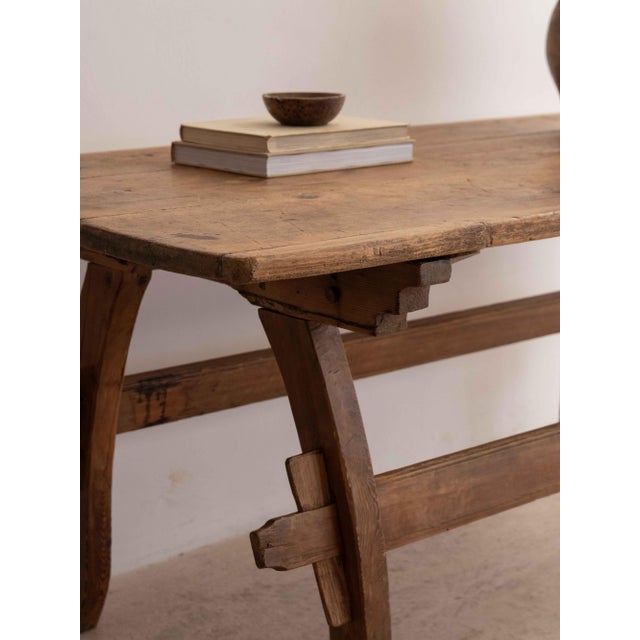 Refined trestle table crafted from solid antique pine. The rectangular top, enhanced by an authentic, warm, and time-worn...