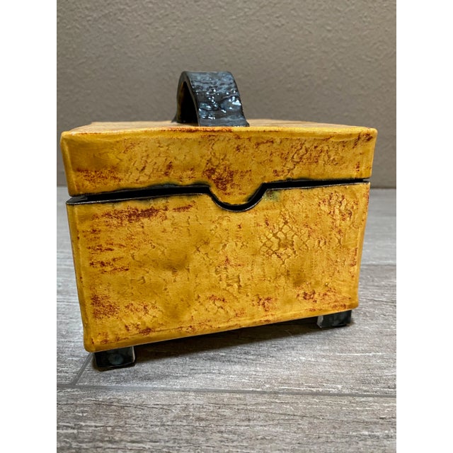 Wonderfully crafted one of a kind box made of pottery. And the artist took the effort to make a wonderful top with handle....