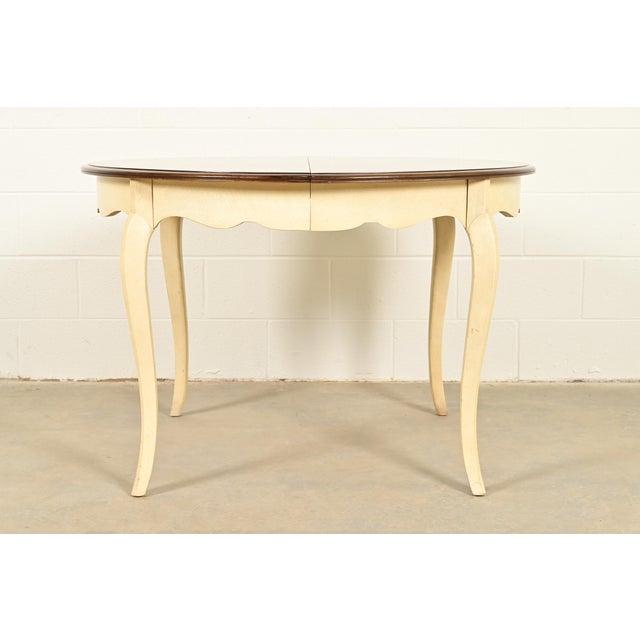 A gorgeous French Provincial Louis XV style dining table or breakfast table By Drexel USA, 1962 Carved walnut, with cream...