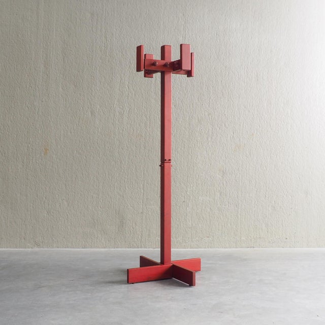 This postmodern coat hanger is constructed from red-stained pine wood, showcasing a bold, architectural silhouette...