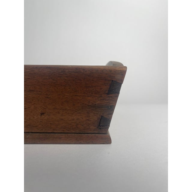 This mahogany knife tray, likely dating to the late 18th or early 19th century, is a fine example of elegant yet practical...