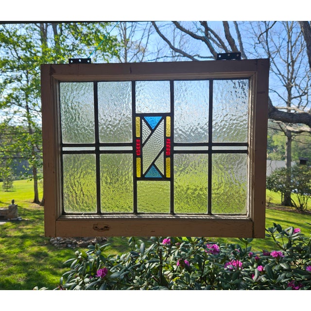 A beautiful vintage stained glass New Orleans transom window featuring water glass, rich texture, and a stunning geometric...