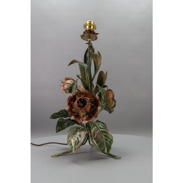 Hollywood regency style green and red painted toleware flower-shaped table lamp, germany, circa the 1970s. This impressive...