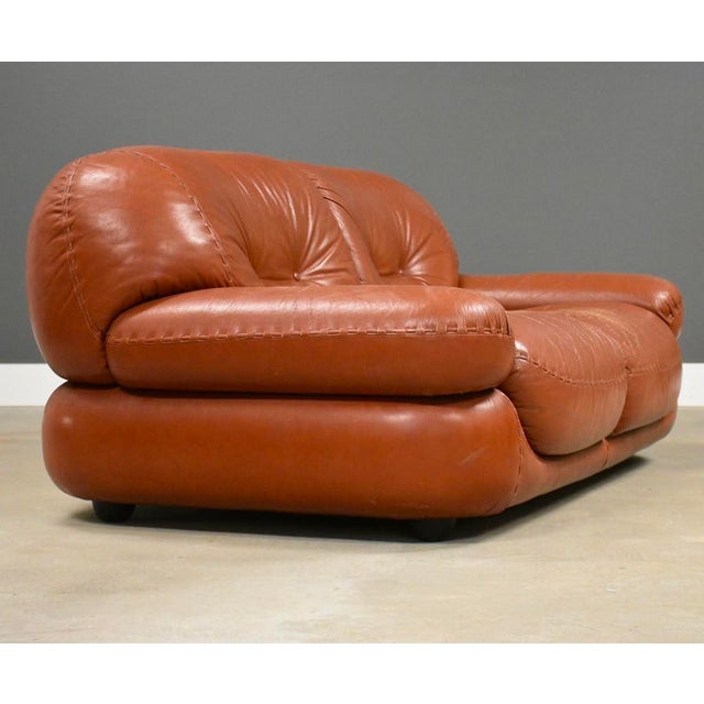 A post modern brown leather Sapporo loveseat sofa designed by Mario Marenco for Mobilgirgi. Attempt to restore color to...