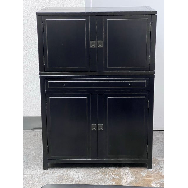 Design Plus Gallery presents a Clyde Bar Cabinet from Pottery Barn. This structured storage piece is defined by clean...