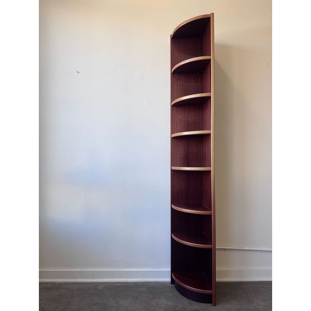 Danish modern tall corner bookshelf in richly toned rosewood. Designed to fit neatly into a corner while still making a...