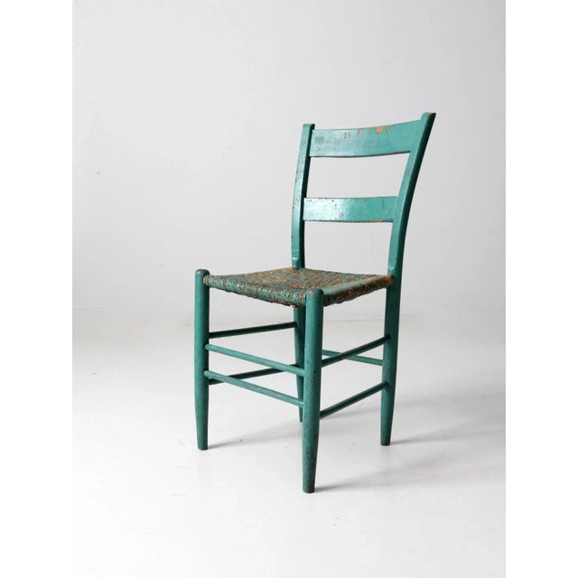 This is an antique rush seat chair. The rustic wooden chair features a woven rush seat and beautifully aged turquoise...