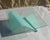 Coffee table with a frosted glass "sail" base supporting a clear, square glass top 12 mm thick. The design is attributed...