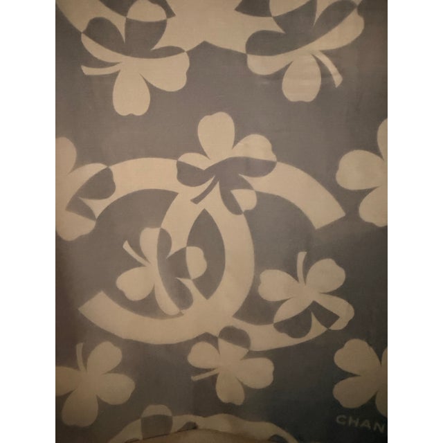 Chanel large silk chiffon scarf This charming scarf features four-leaf clovers and four large "CC" logos in shades of...