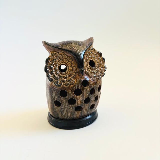A sweet mid century pottery owl votive candle holder. Lovely stylized detailing throughout with a brown and black glaze....